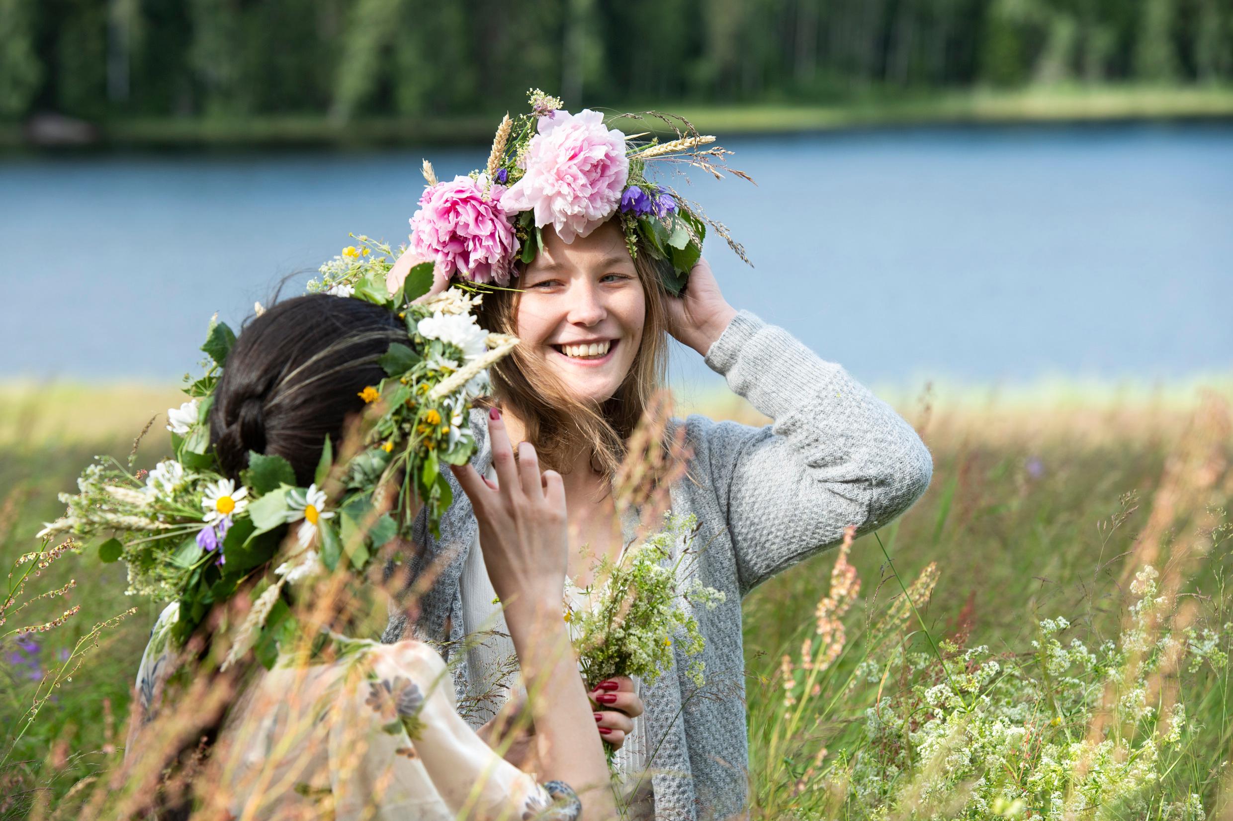 Two girls with Midsummer wreaths on their heads.