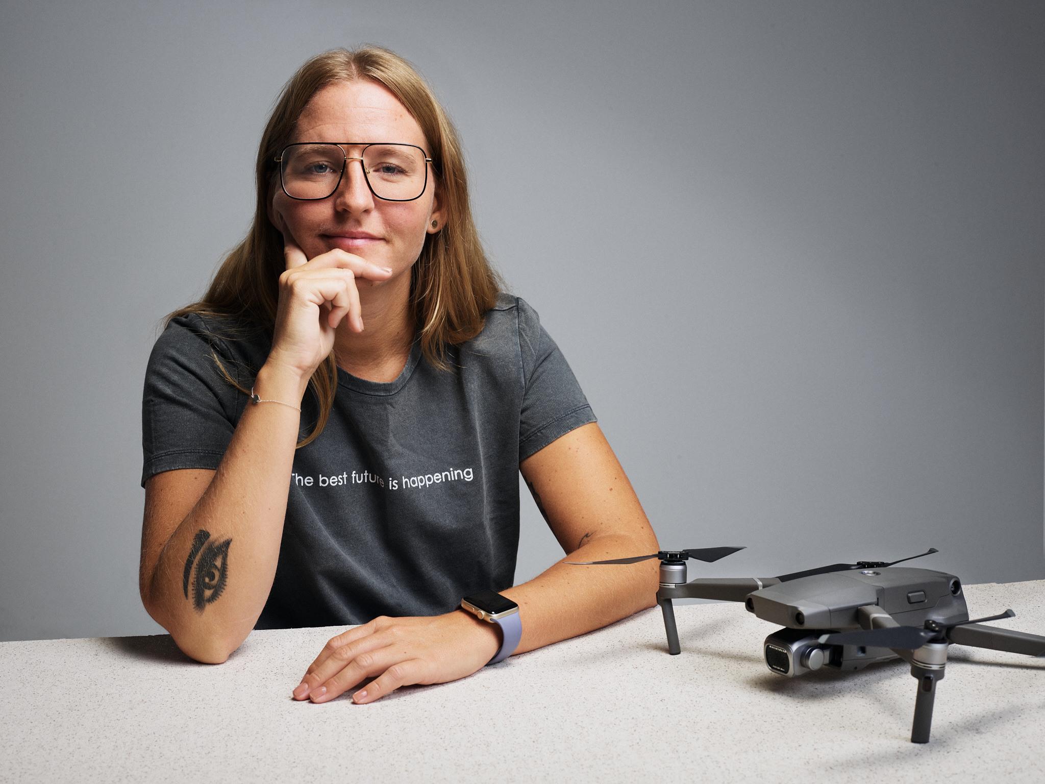 Portrait of Helena Samsioe with a drone on the table in front of her.