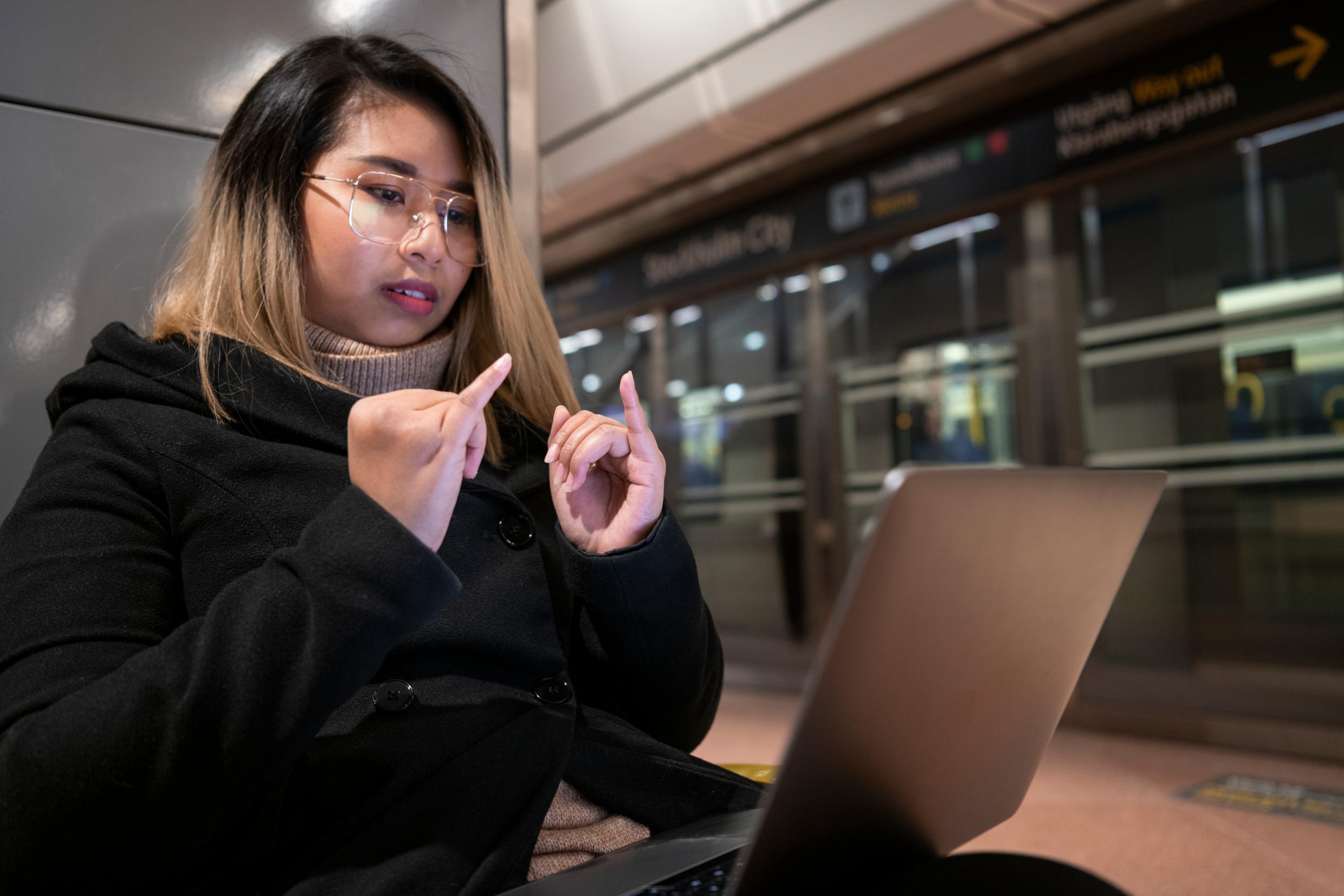 A woman uses sign language.