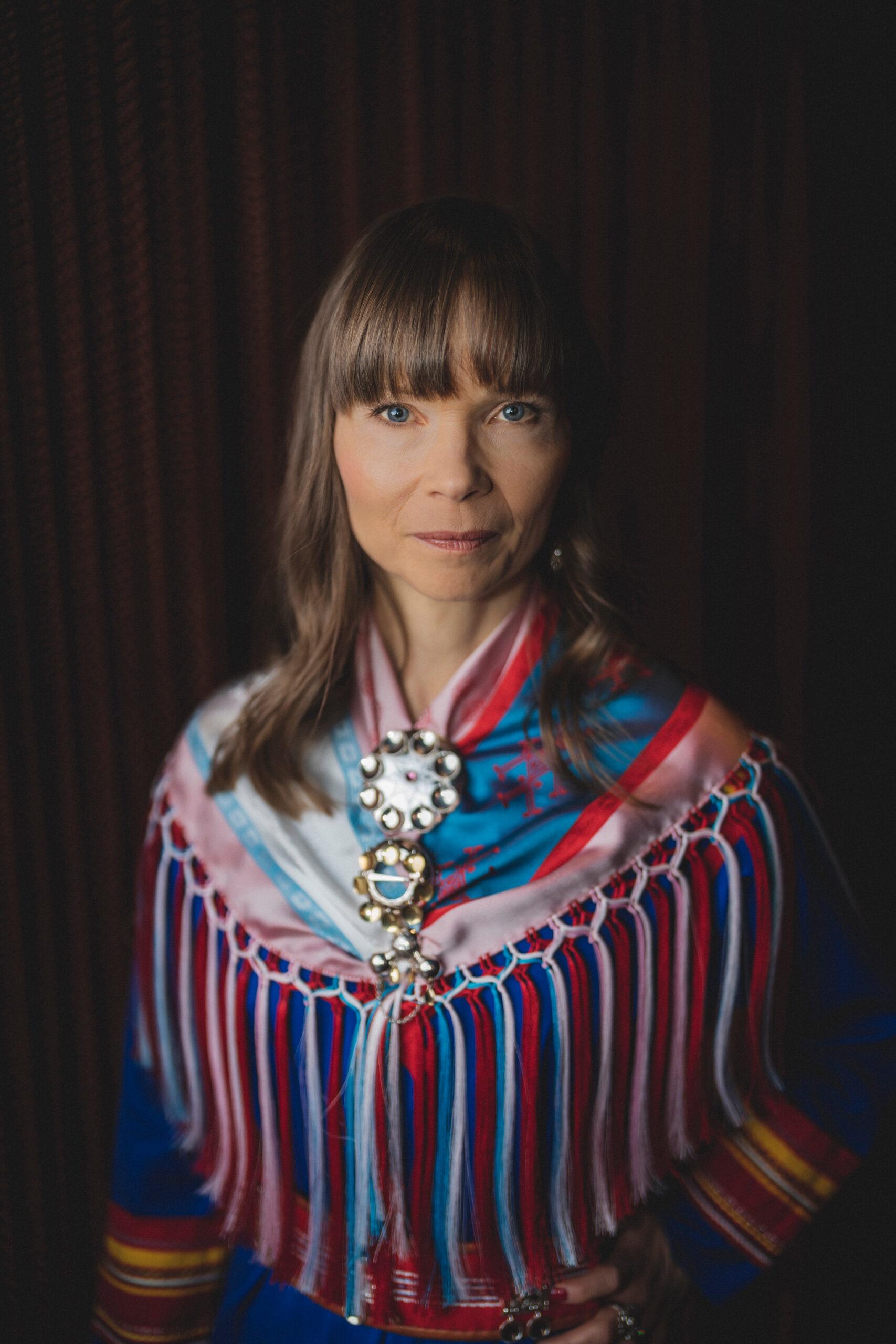 Portrait of a woman in traditional Sami clothing.
