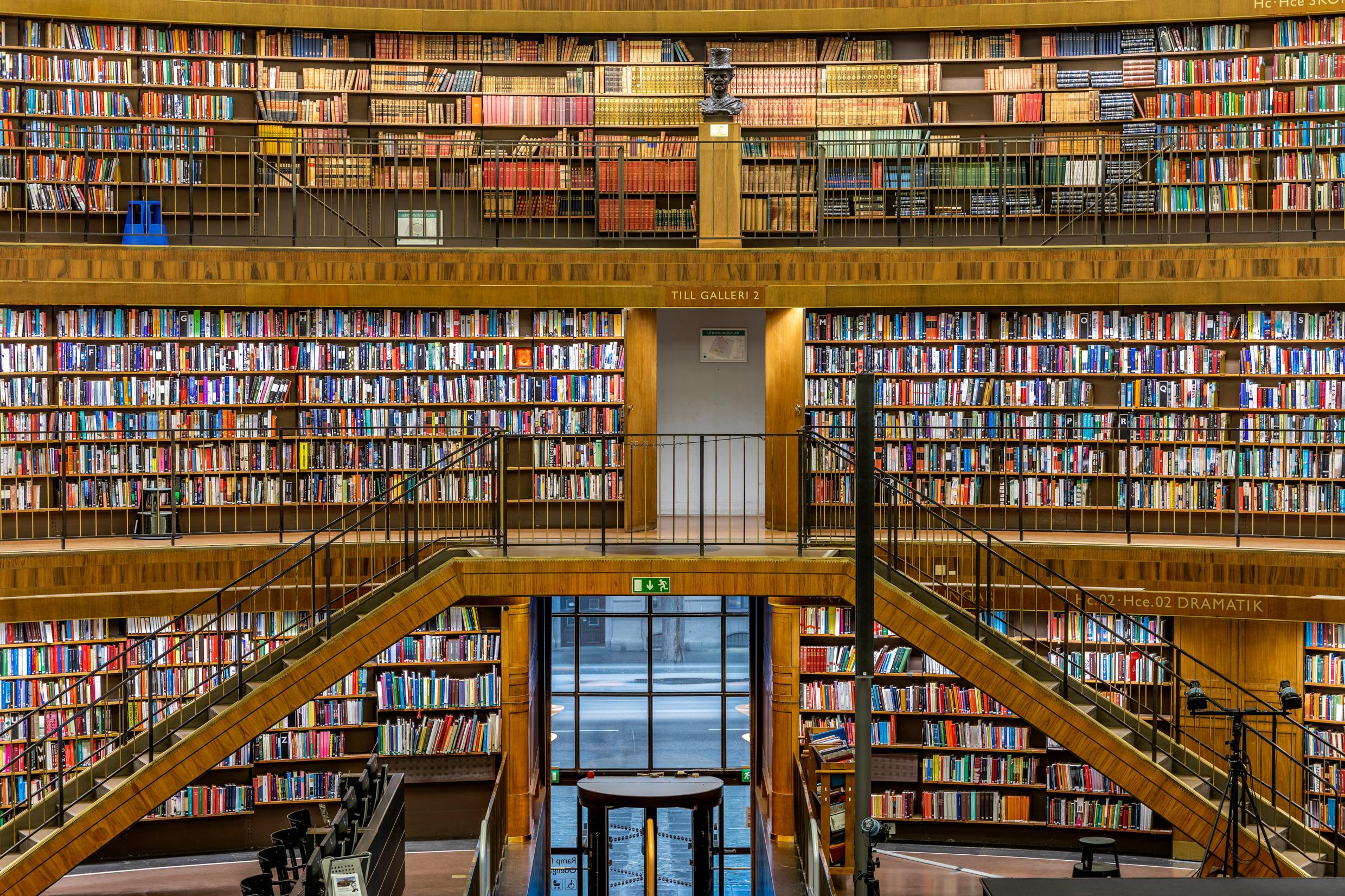 Three stories of books, with a staircase in the centre.