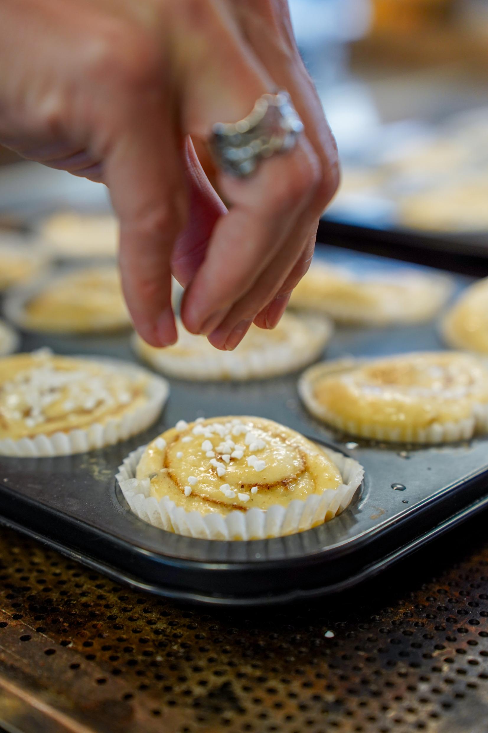 People baking cinnamon buns.