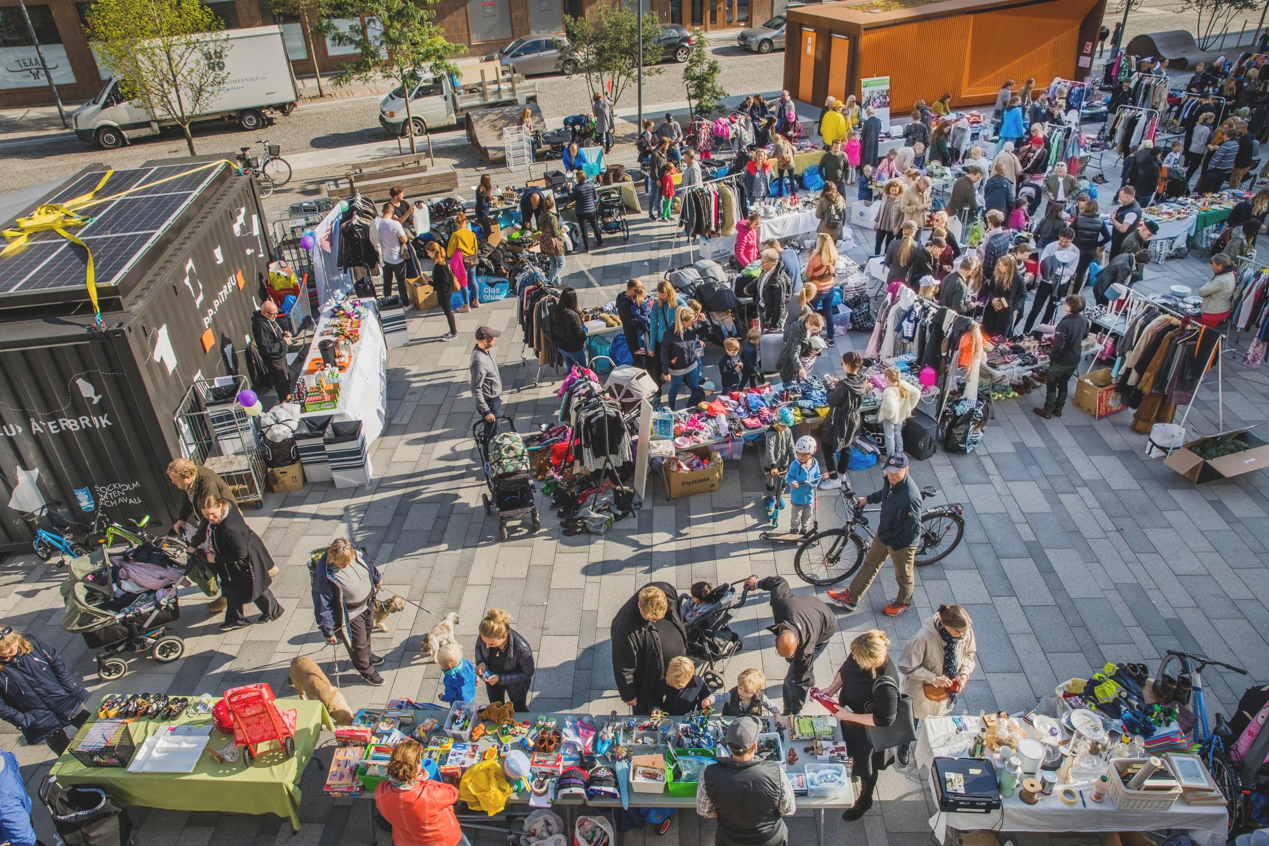 People peruse reused merchandise outdoors.