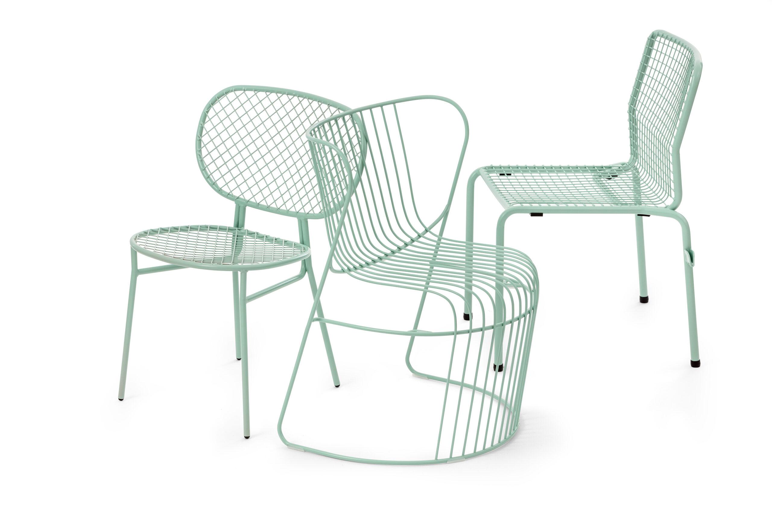 Three mint green chairs made with ribbons of curved steel.