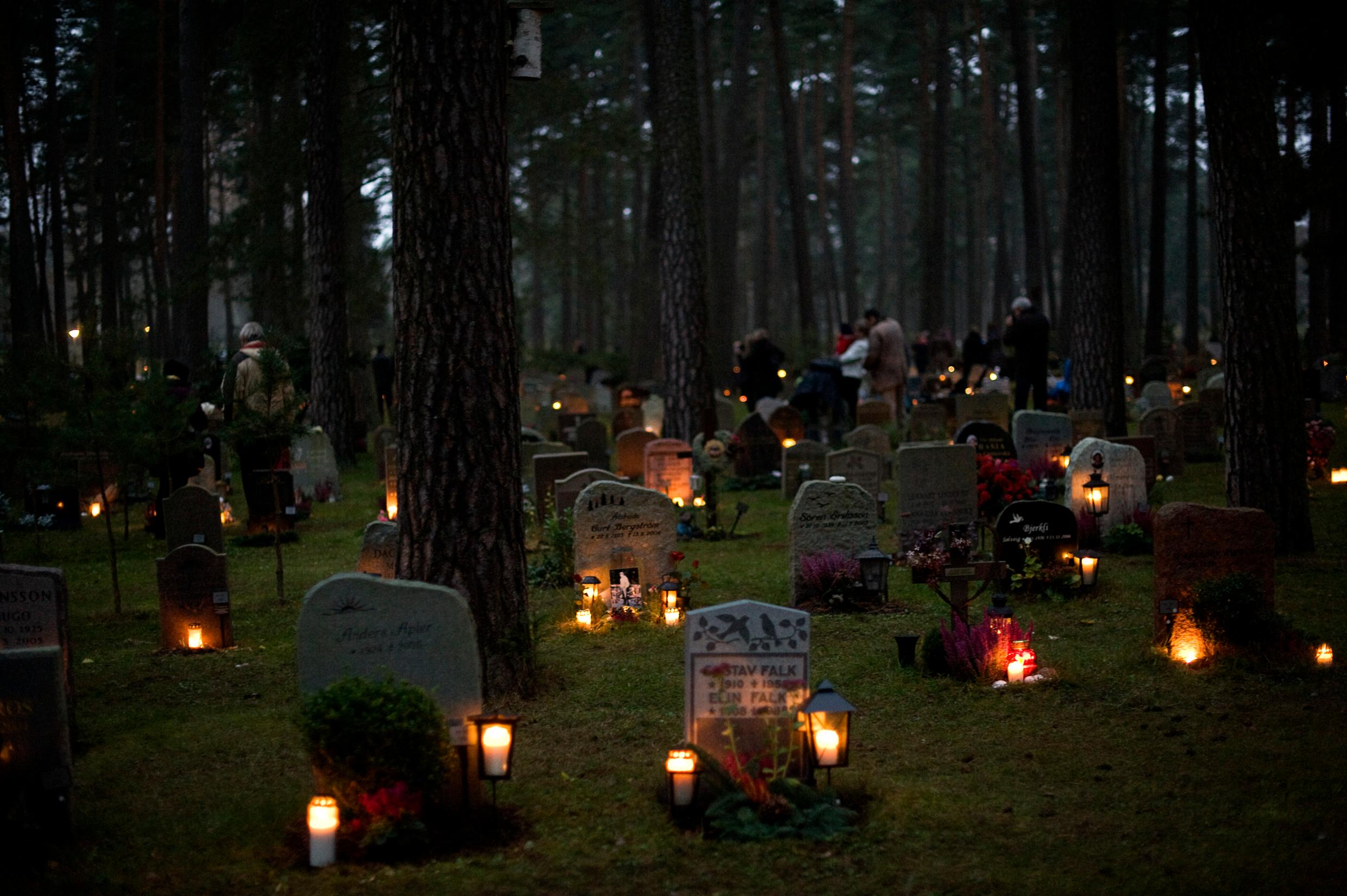 Stockholm's Woodland Cemetery lit up by candles on the graves.
