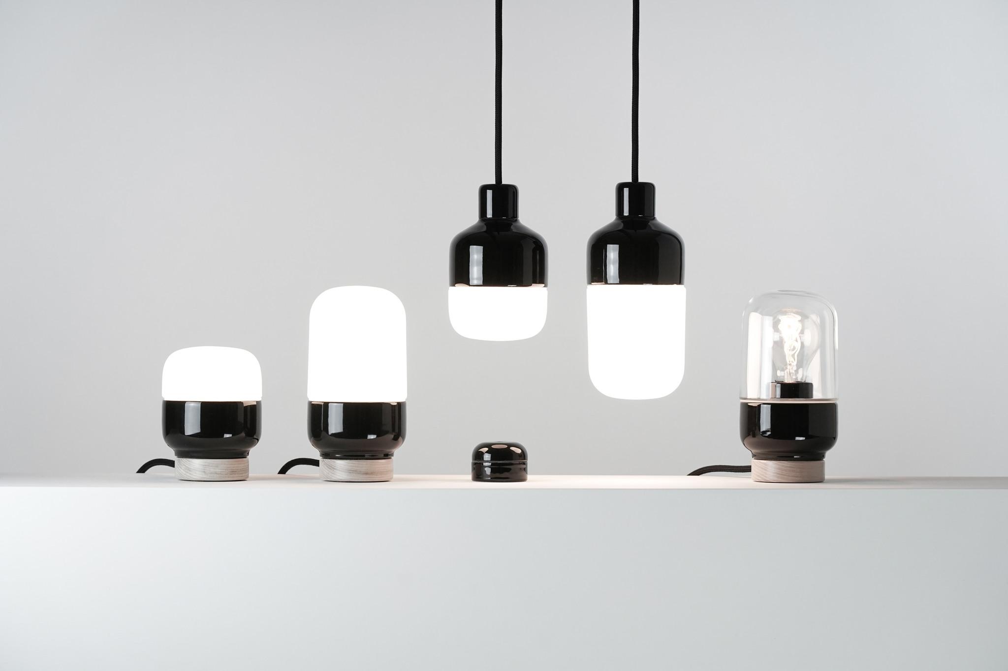 A collection of lamps with a simple black porcelain design.