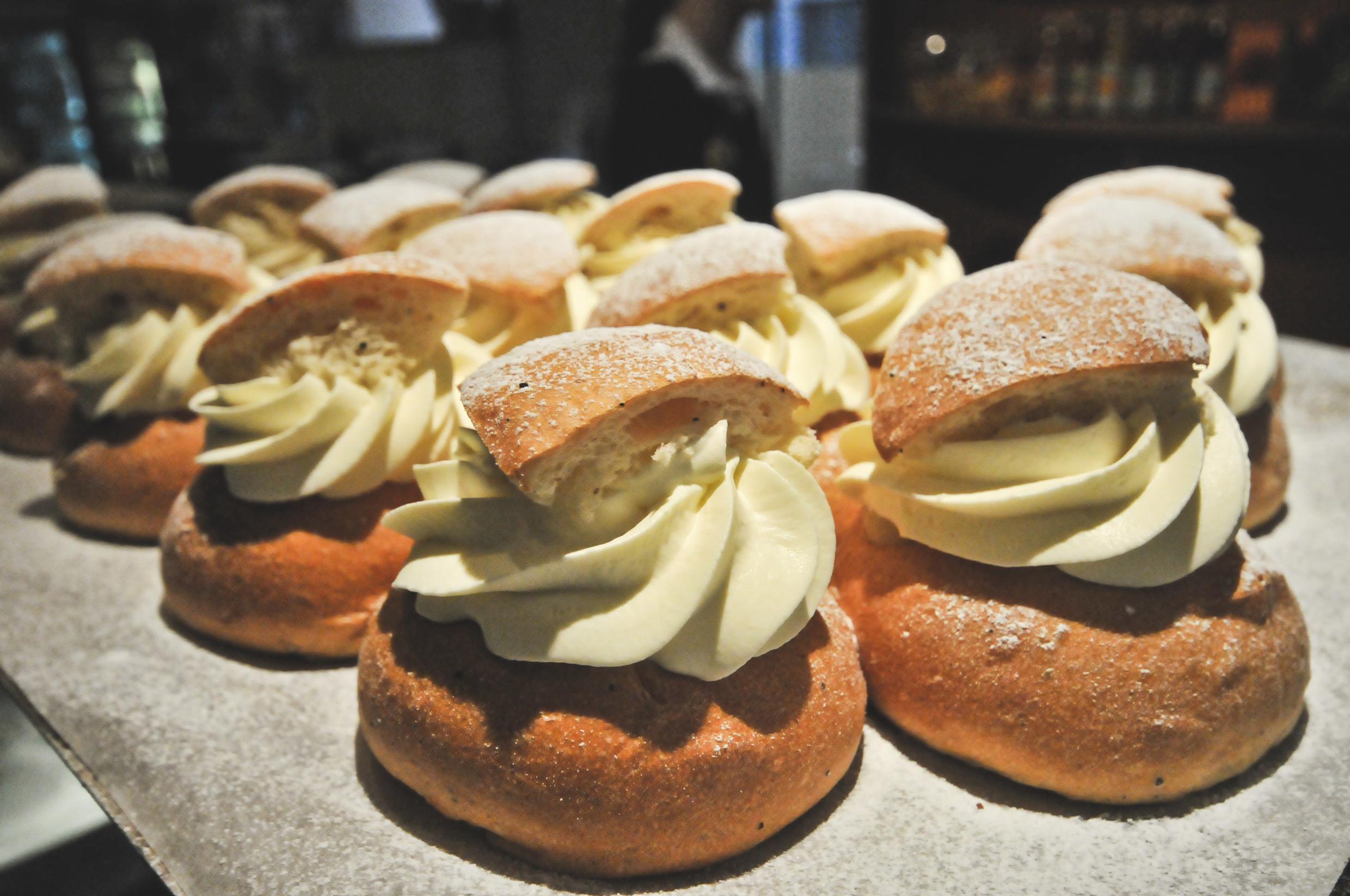 Semlor, buns with whipped cream, are lined up on display.