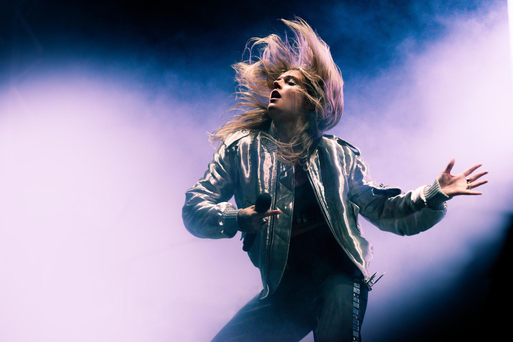 Woman with long hair and microphone on a stage. Tove Lo has been selected to this list of Swedish women.