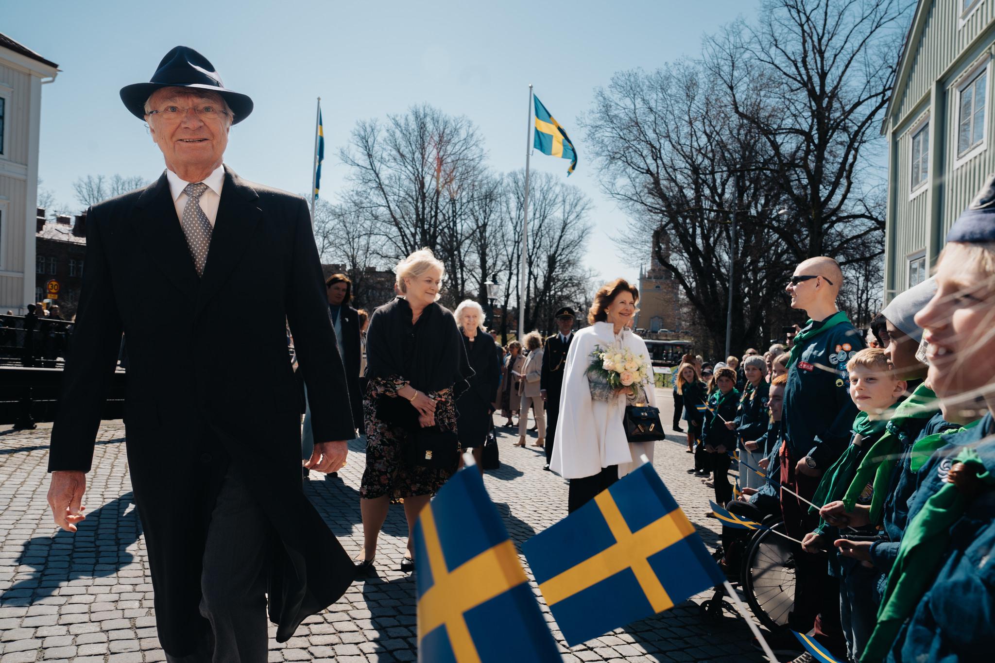 King Carl XVI Gustaf and Queen Silvia are greeted by scout members during a visit to Karlskrona. 