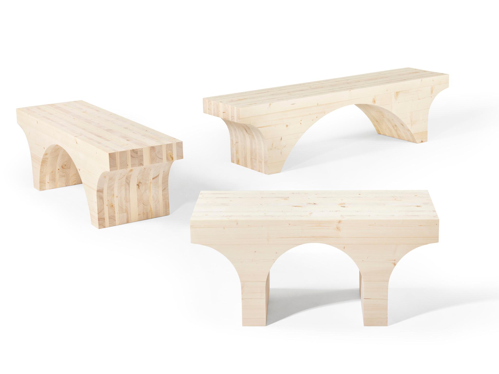 Three wooden benches with arches underneath.